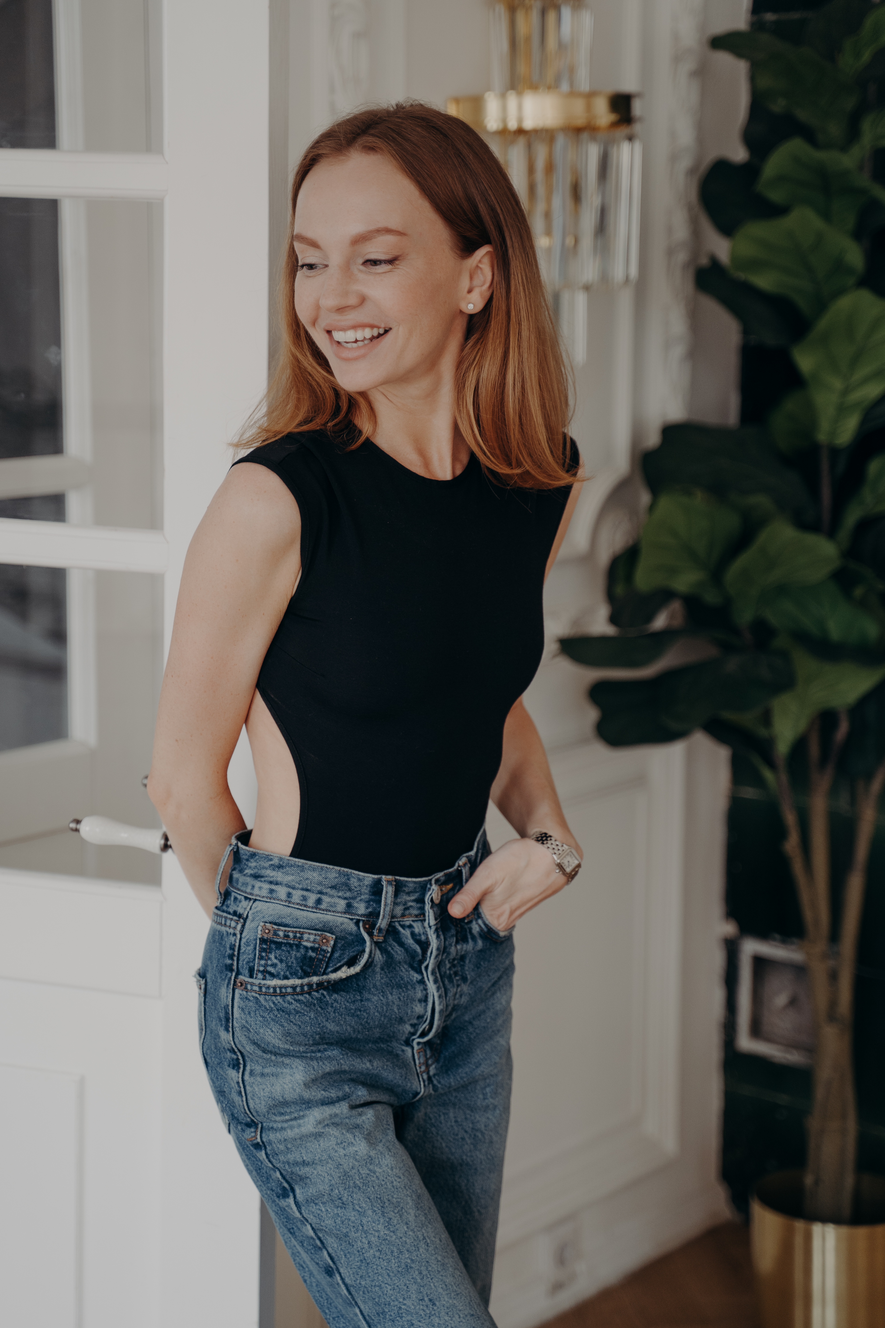 Woman in casual outfit smiling indoors.